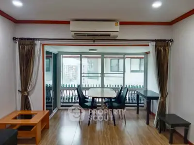 Spacious living room with balcony access and modern furnishings