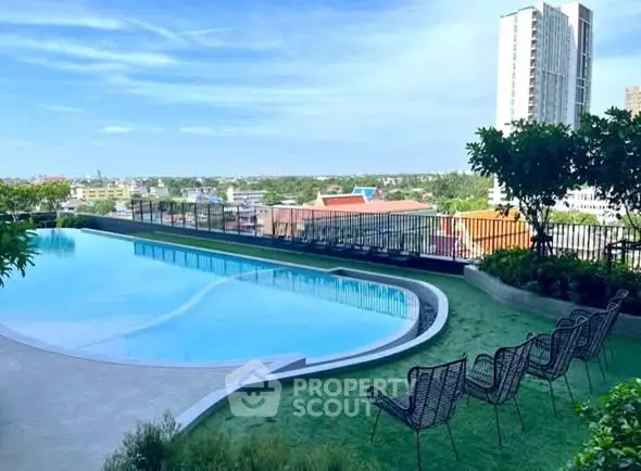 Stunning rooftop pool with panoramic city views and modern seating area.
