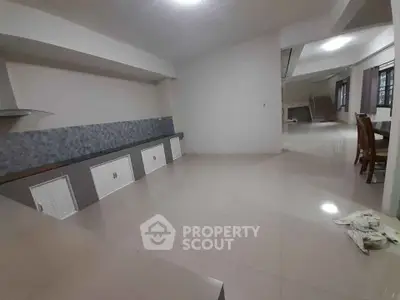 Spacious open layout living area with tiled flooring and modern design
