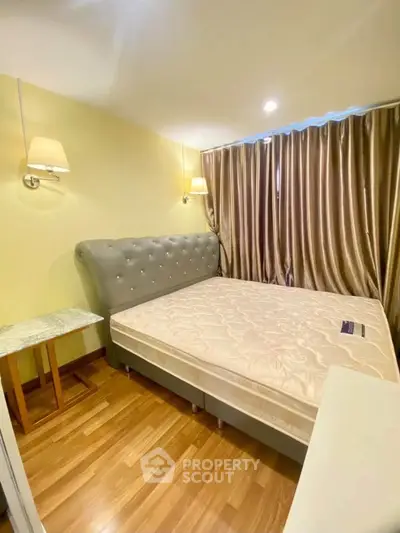 Spacious bedroom with elegant bed and wooden flooring in modern apartment
