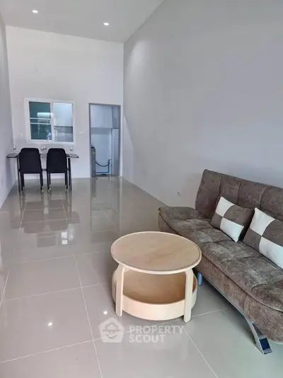 Modern living room with sleek furniture and glossy tiled floor, perfect for contemporary living.