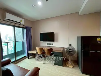 Modern living room with balcony view, sleek furniture, and air conditioning in urban apartment.