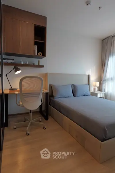 Modern bedroom with stylish desk and cozy bed, perfect for urban living.