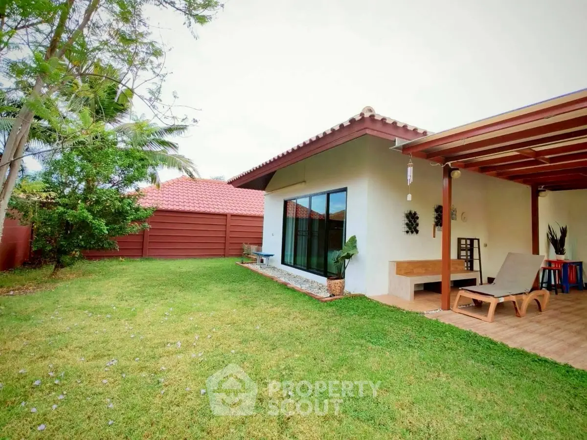 Charming backyard with lush lawn and cozy patio in suburban home