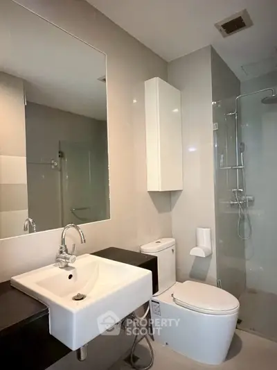 Modern bathroom with sleek fixtures and glass shower enclosure