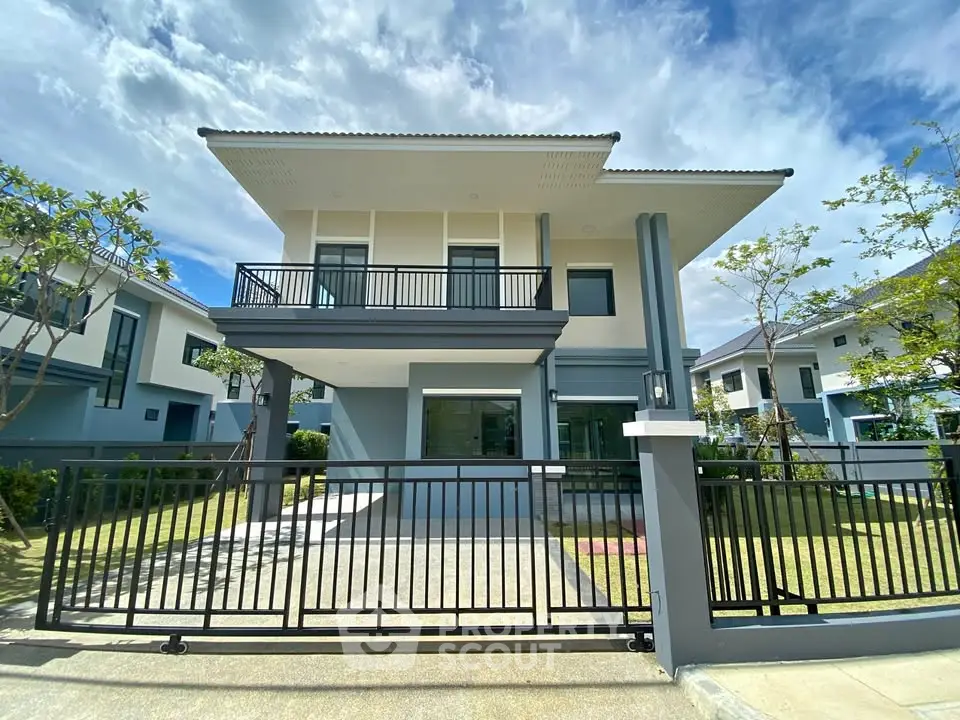 Modern two-story house with sleek design and spacious front yard