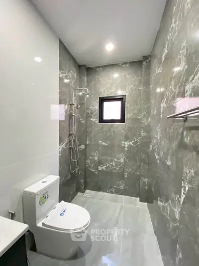 Modern bathroom with sleek marble tiles and contemporary fixtures