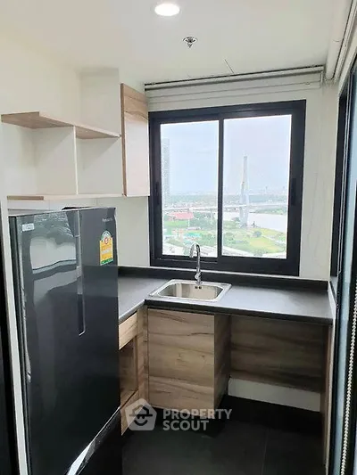 Modern kitchen with sleek design and stunning city view from the window.