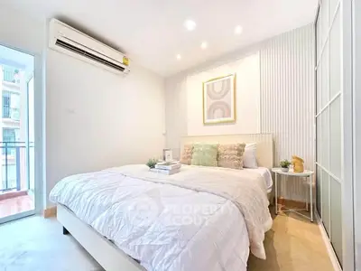 Bright and cozy bedroom with modern decor and balcony access