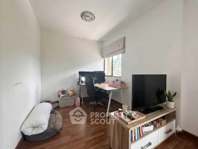 Cozy study room with desk, chair, and TV, perfect for work or relaxation.