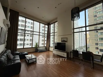 Spacious modern living room with floor-to-ceiling windows and city view