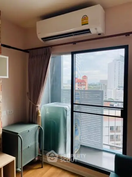 Cozy apartment corner with air conditioning and city view from balcony.
