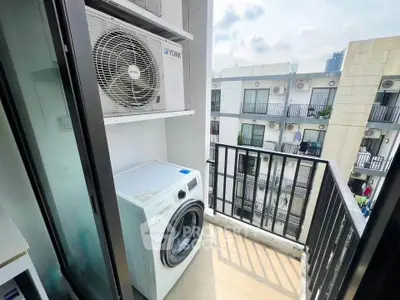 Modern apartment balcony with washing machine and city view, perfect for urban living.
