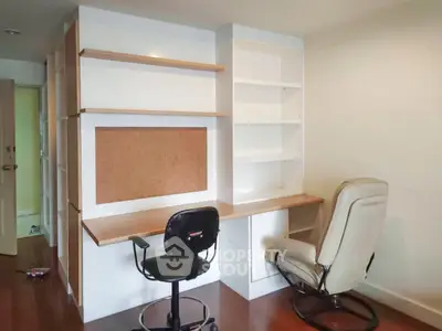 Spacious study room with built-in shelves and ergonomic chairs