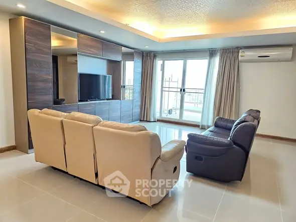 Spacious modern living room with sleek furniture and large windows for natural light.