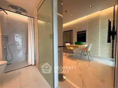 Luxurious modern kitchen with marble flooring and adjacent sleek bathroom featuring a spacious shower.