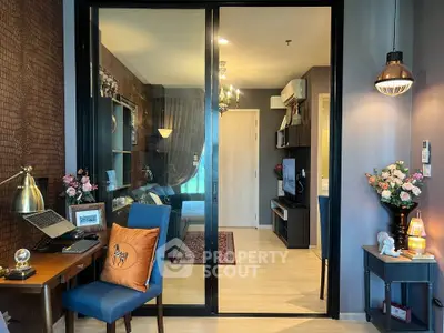Modern apartment interior with stylish decor, featuring a cozy living area and a glimpse into the bedroom.