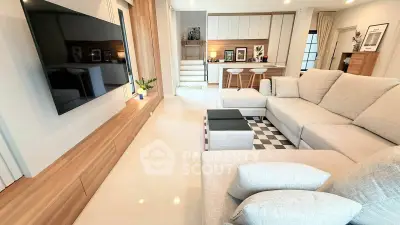 Spacious modern living room with large sofa and wall-mounted TV