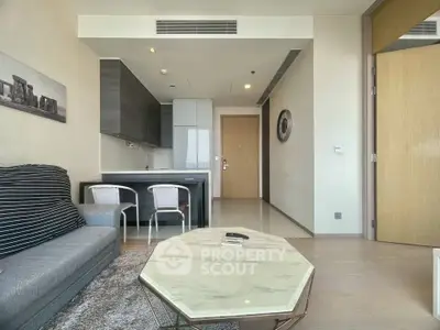 Modern living room with open kitchen, stylish furniture, and elegant decor in a contemporary apartment.