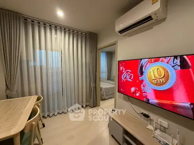 Modern living room with dining area and TV, featuring stylish curtains and air conditioning.