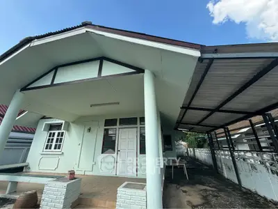 Charming single-story house with covered carport and inviting front porch, perfect for family living.