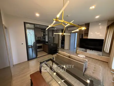 Modern living room with stylish lighting and open kitchen layout