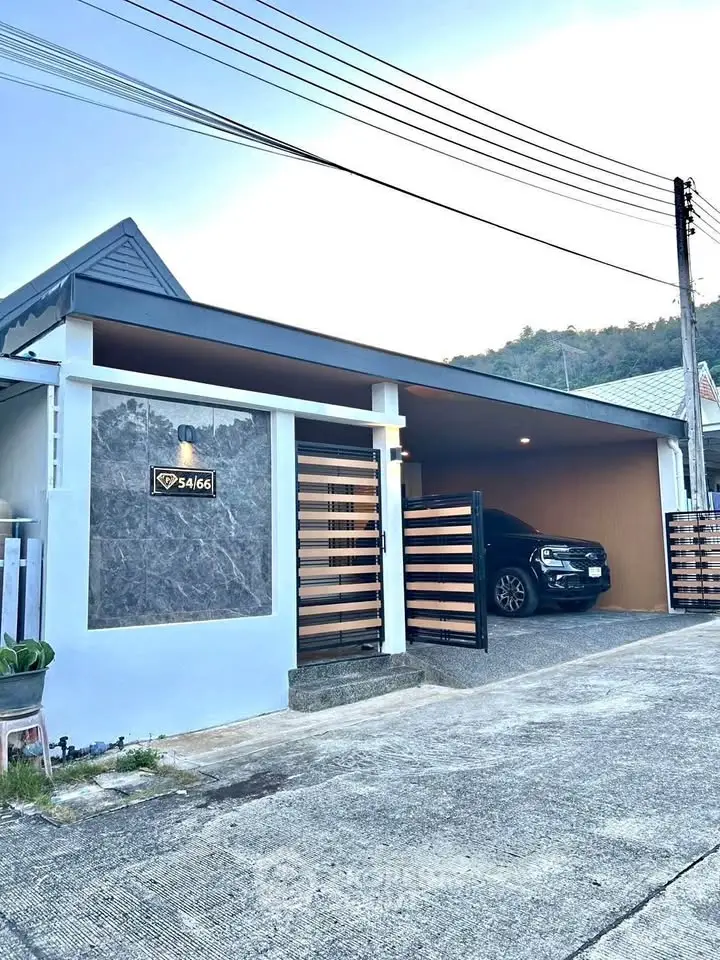 Modern single-story house with carport and stylish gate in a serene neighborhood.