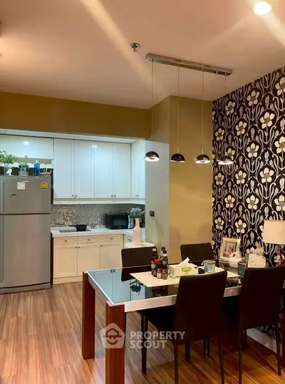 Modern kitchen with dining area, stylish wallpaper, and sleek appliances.