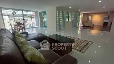 Spacious modern living room with sleek design and abundant natural light, perfect for family gatherings.