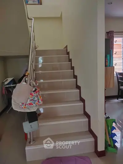 Charming interior staircase with modern railing in a cozy home setting, perfect for family living.