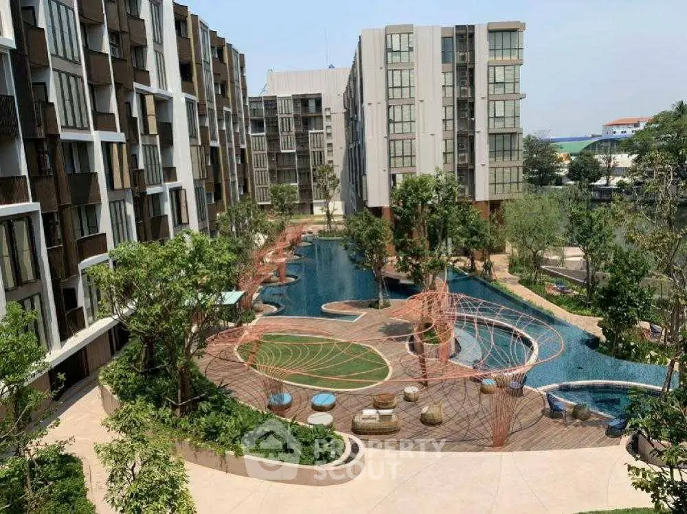 Luxurious condo complex with stunning pool and lush gardens