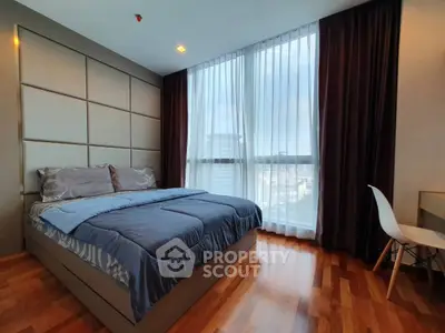 Luxurious bedroom with large window and elegant decor in modern apartment