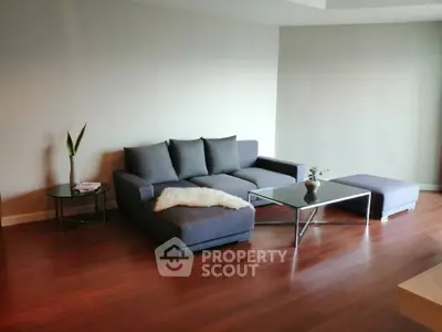 Modern living room with sleek furniture and wooden flooring, perfect for stylish urban living.