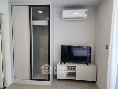 Modern living room with sleek TV stand and air conditioning unit
