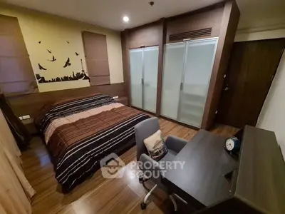 Cozy bedroom with modern decor and study desk, perfect for relaxation and productivity.