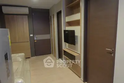 Modern apartment hallway with sleek wooden finishes and mounted TV