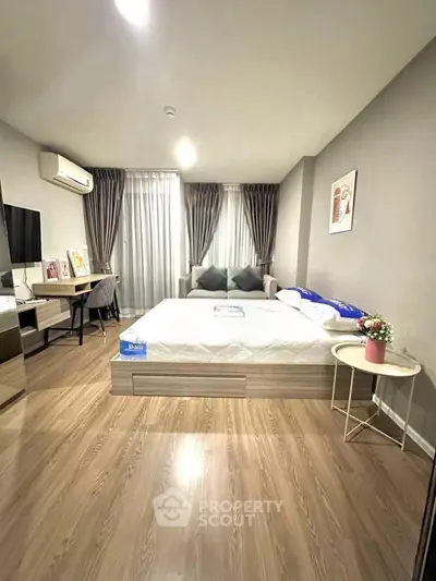 Spacious modern bedroom with stylish decor and natural light