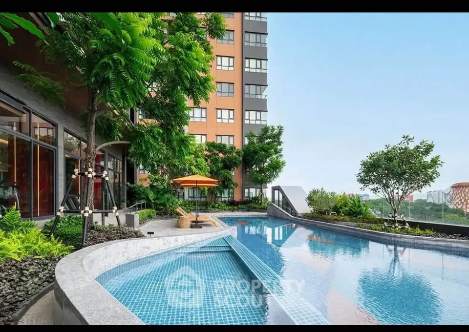Luxurious apartment building with stunning pool and lush greenery, offering a serene urban oasis.