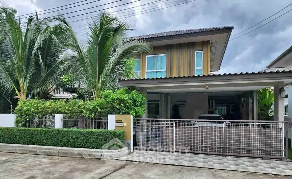 Charming two-story house with lush greenery and spacious driveway in a serene neighborhood.