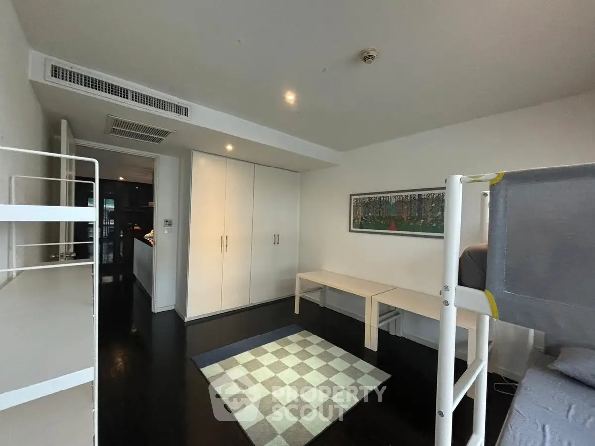 Modern bedroom with bunk bed and sleek storage solutions