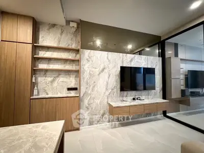 Modern living room with sleek design, wall-mounted TV, and elegant marble accents.