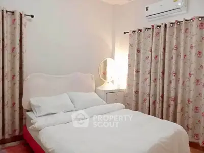 Cozy bedroom with floral curtains and air conditioning unit