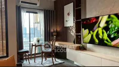 Modern living room with large TV, stylish decor, and city view from window.