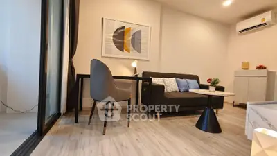 Modern living room with stylish decor and sleek furniture, featuring a cozy sofa and elegant artwork.