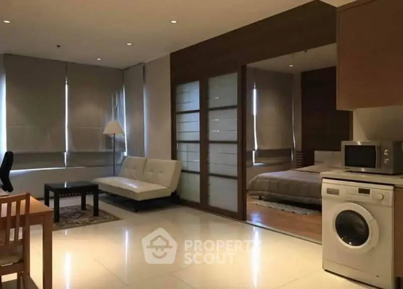 Modern studio apartment with washing machine and cozy furnishings
