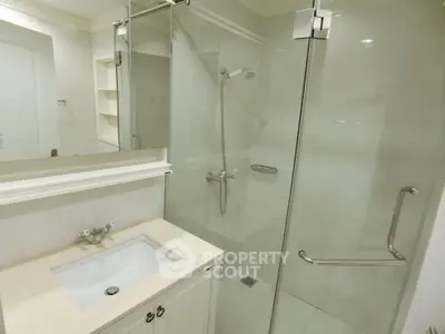 Elegant bathroom with glass shower enclosure and modern fixtures