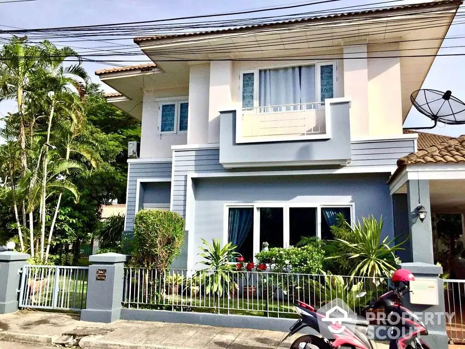 Charming two-story house with lush garden and modern facade in suburban neighborhood.