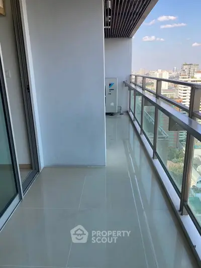 Spacious balcony with city view in modern high-rise apartment