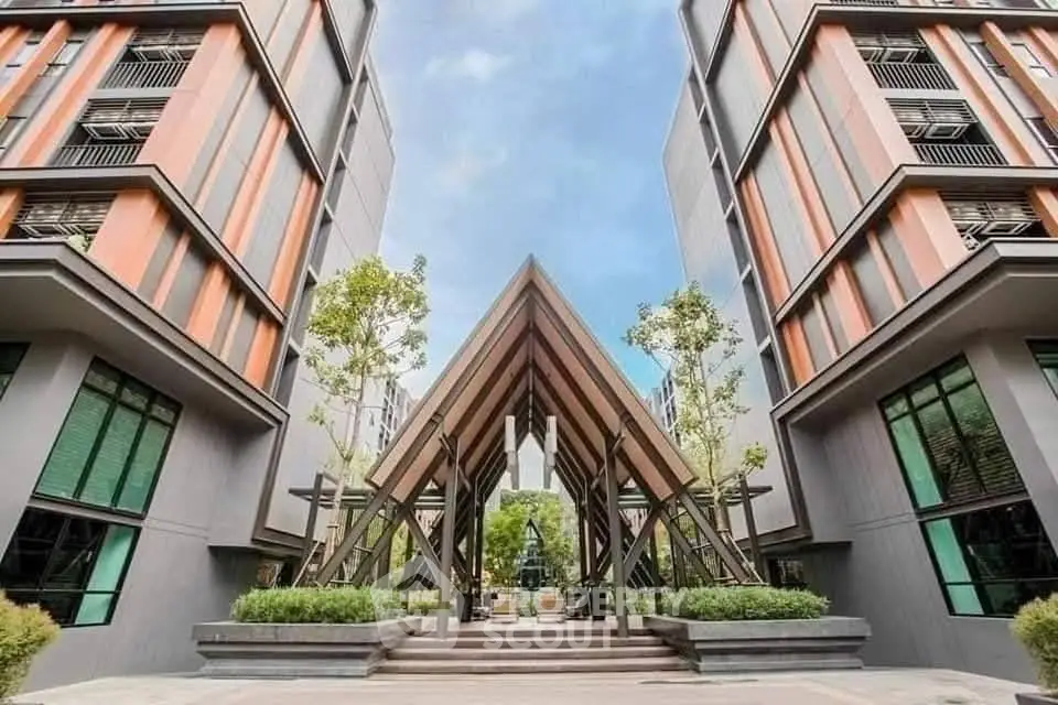Modern architectural entrance of a contemporary residential building with sleek design.