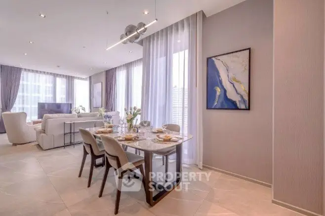 Luxurious open-plan living and dining area with elegant decor and ample natural light.